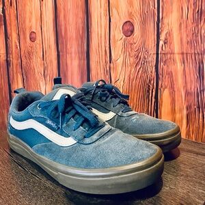 Classic Vans sneakers with blue green suede and signature side stripes.